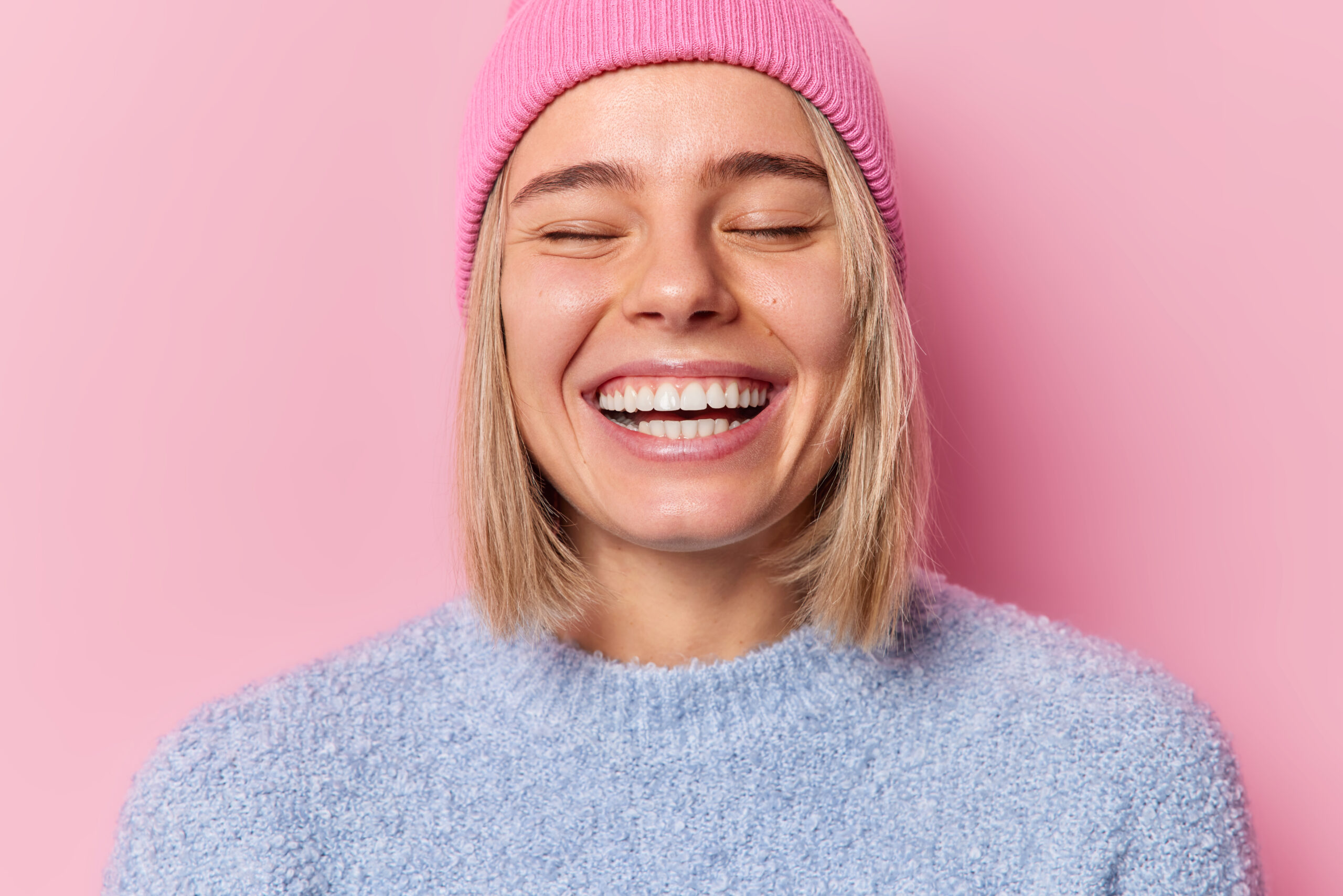 A woman with a healthy smile after successful Gum Recession Treatment in Beverly Hills.