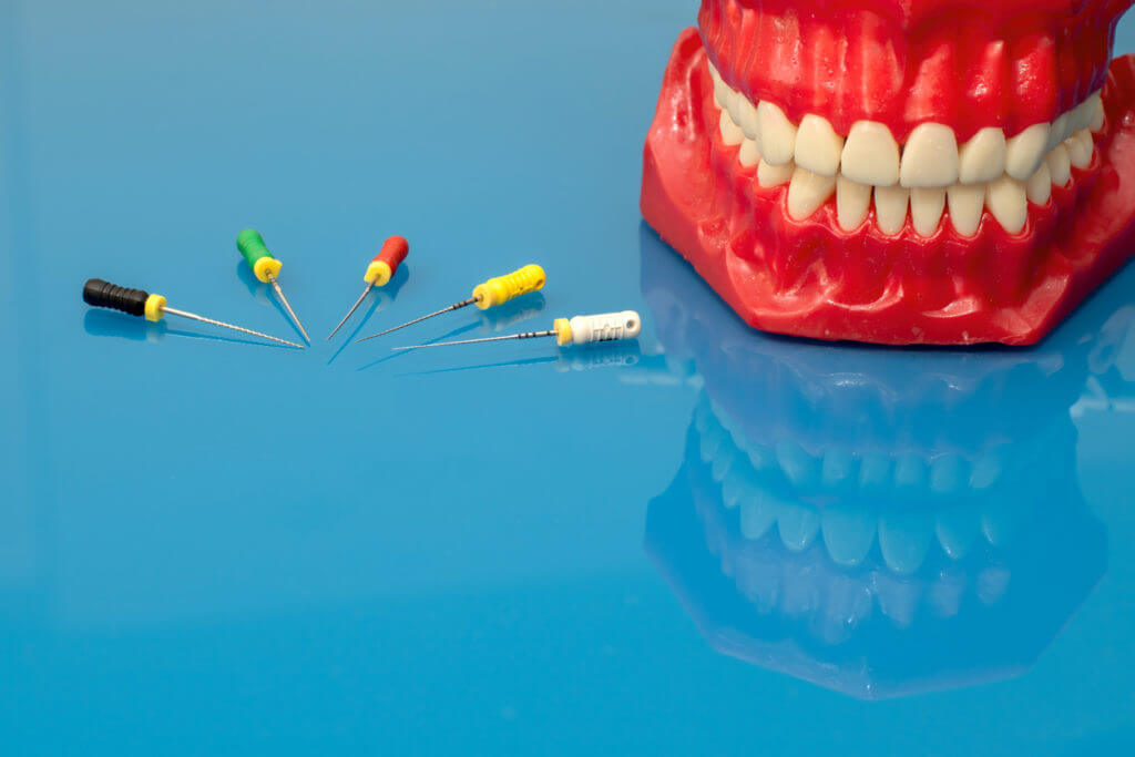 cartoon model of mouth with various capsules and pills next to it