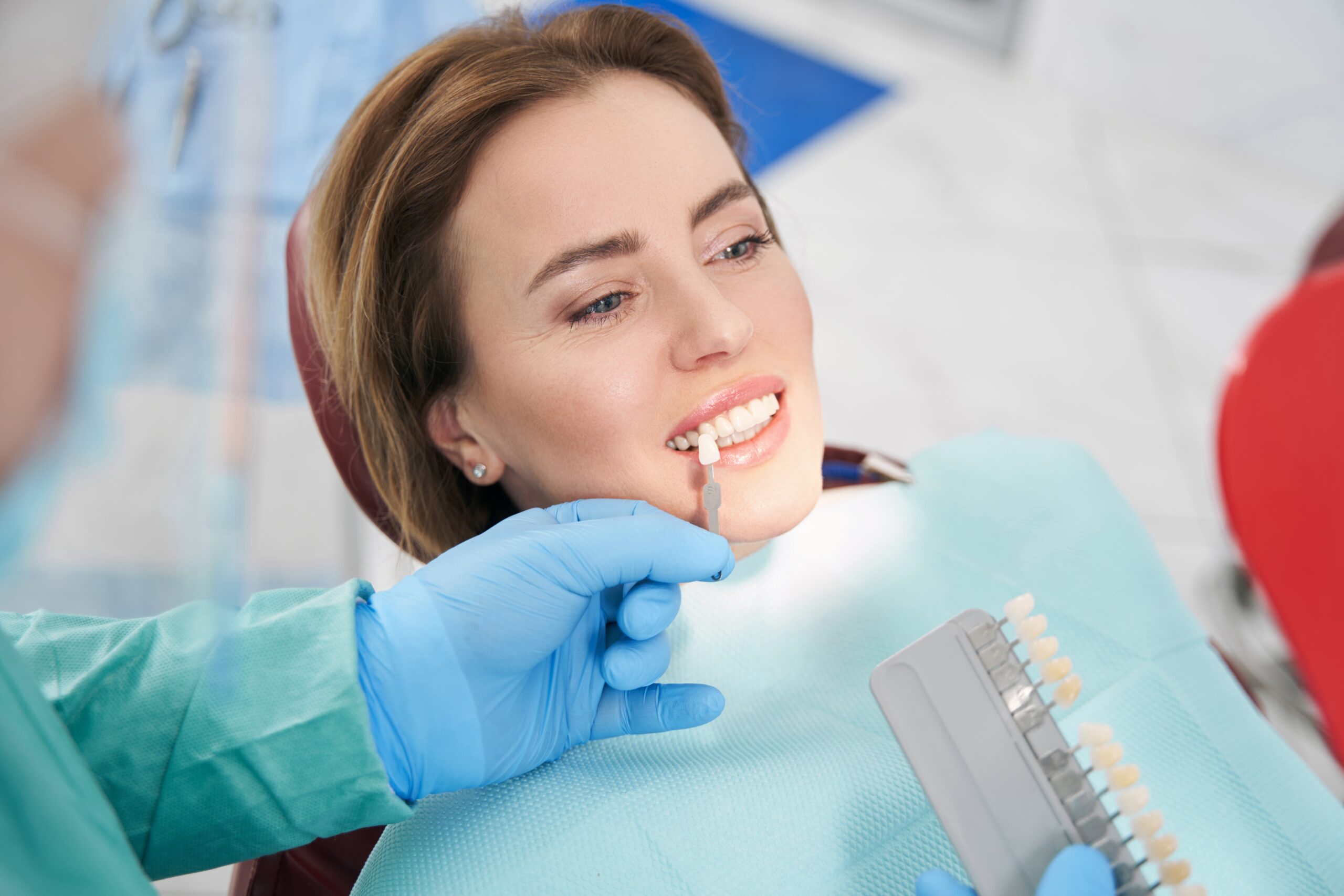 Dental Implant Expert in Beverly Hills holds a tooth shade guide.